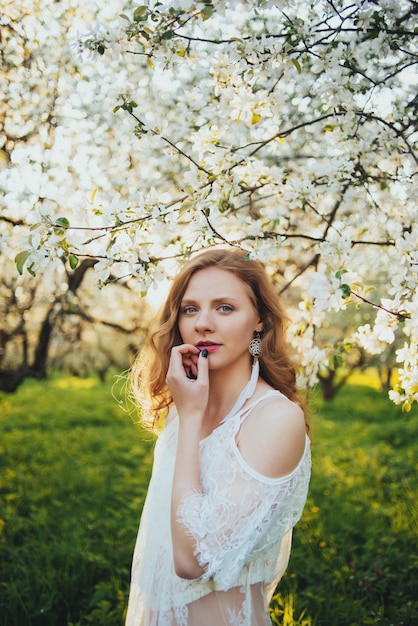 A girl in an apple orchard