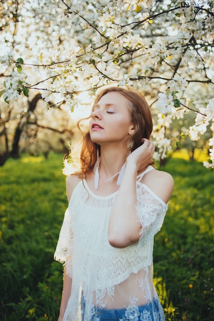 A girl in an apple orchard