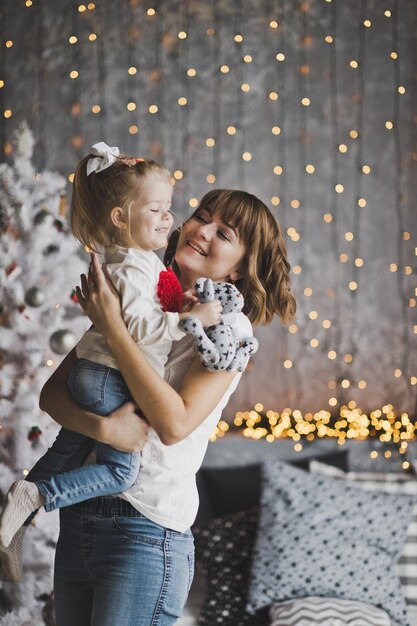 The girl in the arms of my mother in the background of the Christmas tree 7185