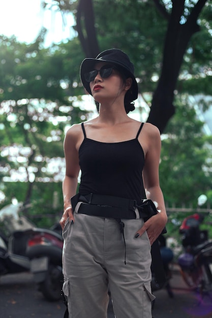 Girl asian in a light hat and sunglasses on a summer day