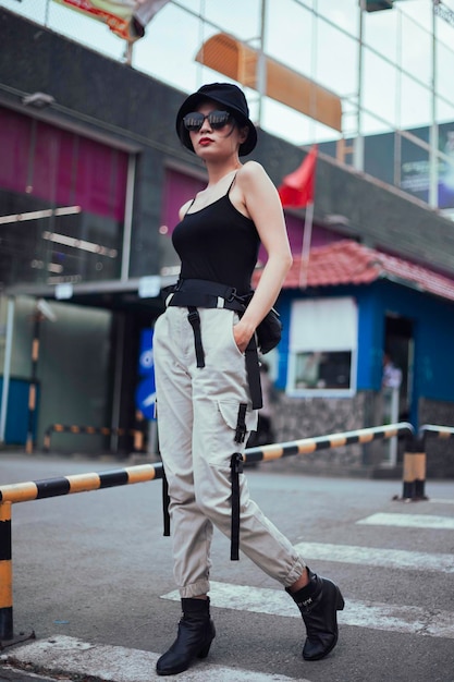 Girl asian in a light hat and sunglasses on a summer day