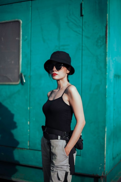 Girl asian in a light hat and sunglasses on a summer day