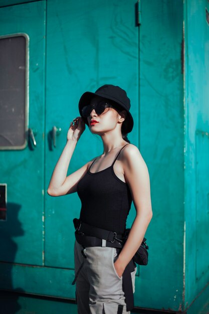 Girl asian in a light hat and sunglasses on a summer day