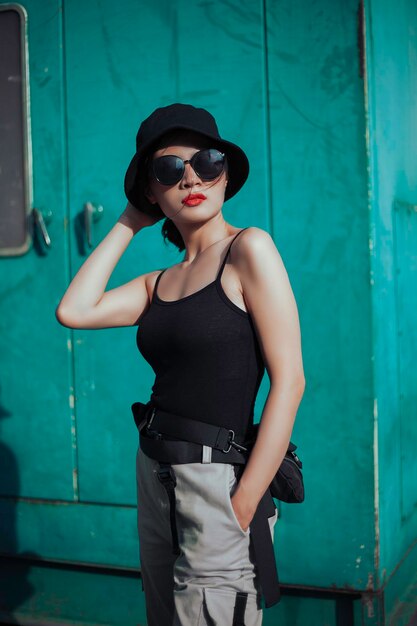 Girl asian in a light hat and sunglasses on a summer day