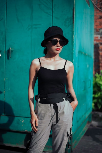 Girl asian in a light hat and sunglasses on a summer day