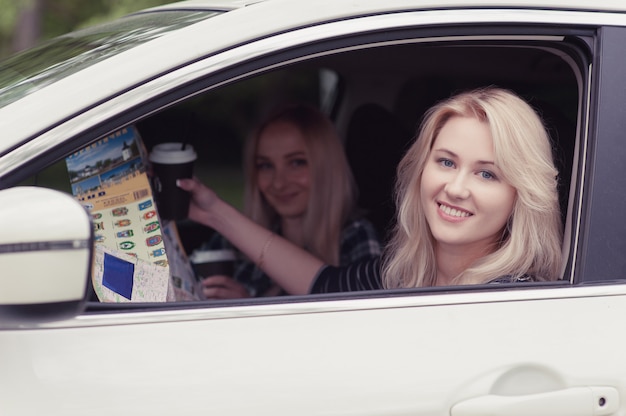 A girl asks for a route, pointing on place on the map