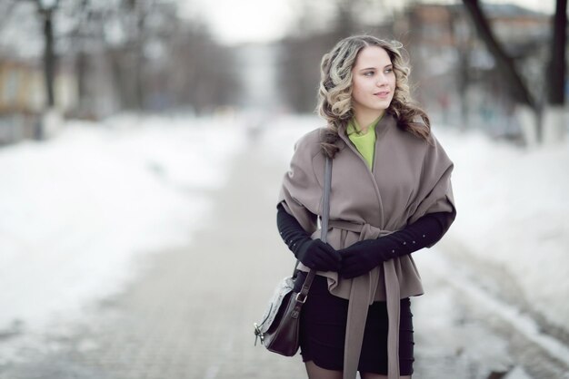 girl in autumn coat and gloves outside winter