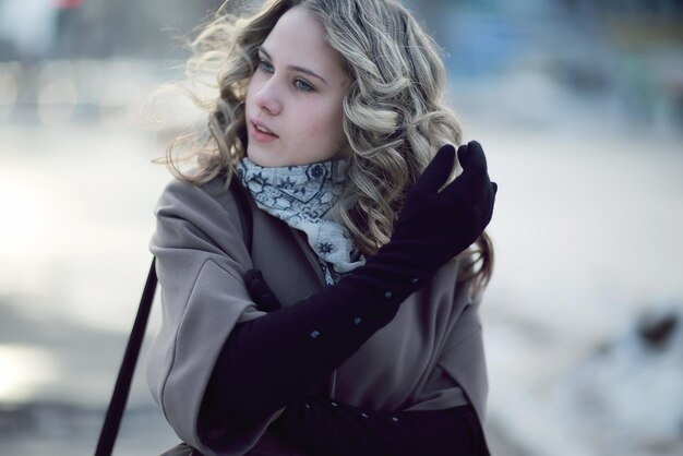 girl in autumn coat and gloves outside winter