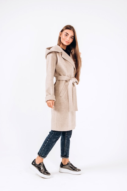 Girl in autumn coat on a white background