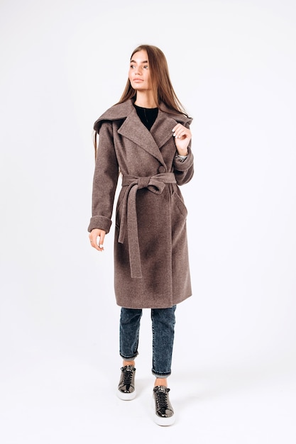 Girl in autumn coat on a white background