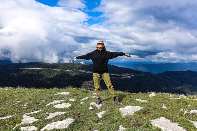 A girl on the background of alpine meadows of the LagoNaki plateau in Adygea Russia 2021