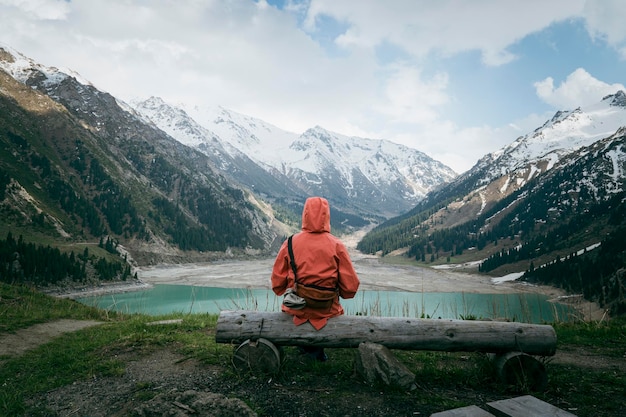 Girl on a background of beautiful sea or lake Girl from behind The girl looks at the magical sea Freedom and happiness Big Almaty Lake Kazakhstan Almaty