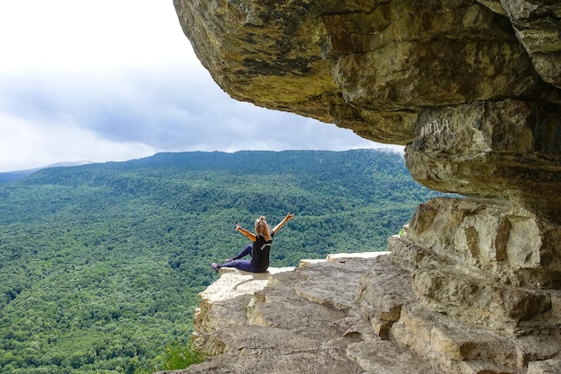 A girl on the background of the landscape of the Caucasus mountains  Eagle rocks Mezmai