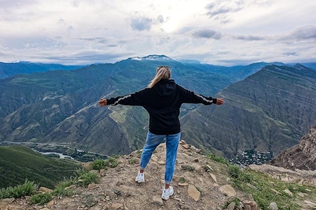 A girl on the background of a mountain view from the ancient village of Goor Russia Dagestan 2021