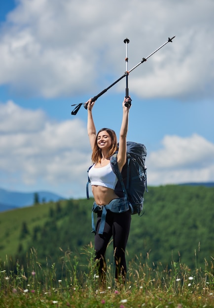 girl backpacker with backpack relaxing after climbing up