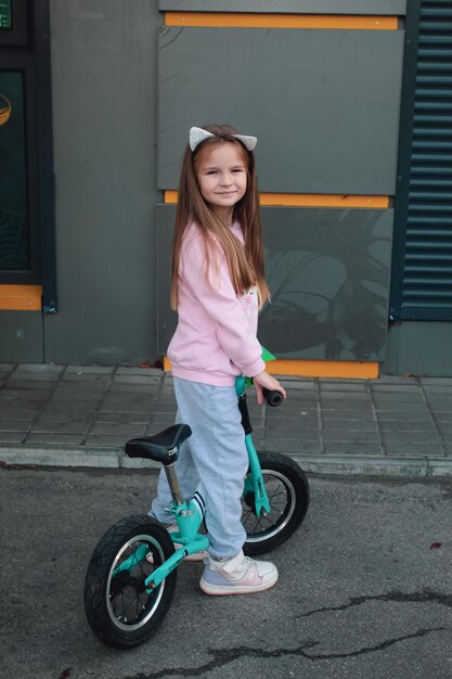 Girl on a balance bike in the city