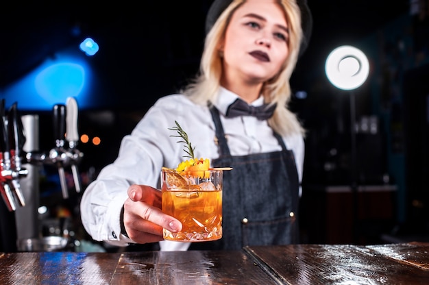 Girl barman concocts a cocktail on the saloon