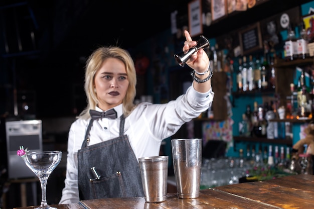 Girl bartender concocts a cocktail in the beerhall