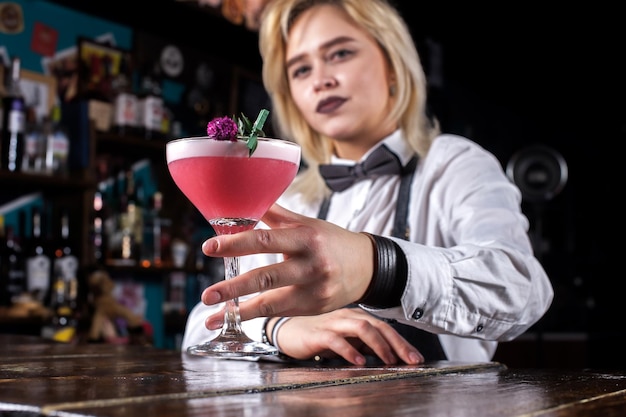 Girl bartender mixes a cocktail at the porterhouse