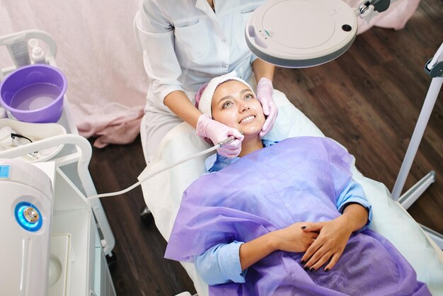 Girl beautician works with patients in the office