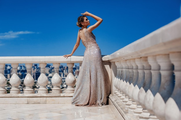 Girl in a beautiful elegant evening dress in the park