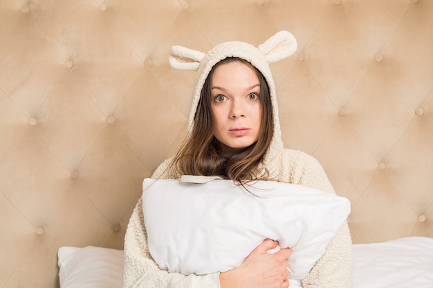 Girl on the bed in funny pajamas