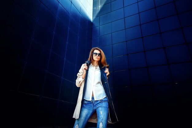 Girl in a beige coat and blue jeans