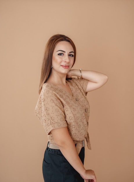 a girl in a beige shirt on a beige background