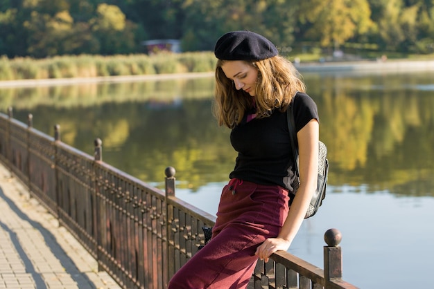 The girl in beret and skirt in the park Cute girl portrait in french style