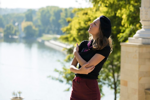 The girl in beret and skirt in the park Cute girl portrait in french style