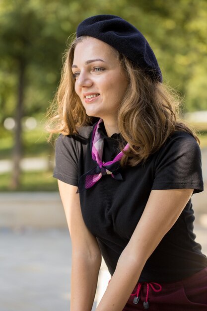 Photo the girl in beret and skirt in the park cute girl portrait in french style