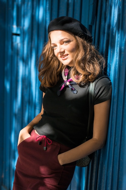 The girl in beret and skirt in the park