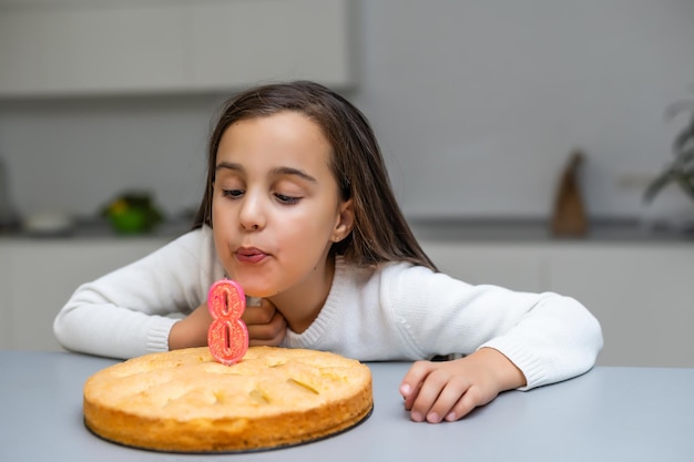 Girl in the birthday with a cake with candle