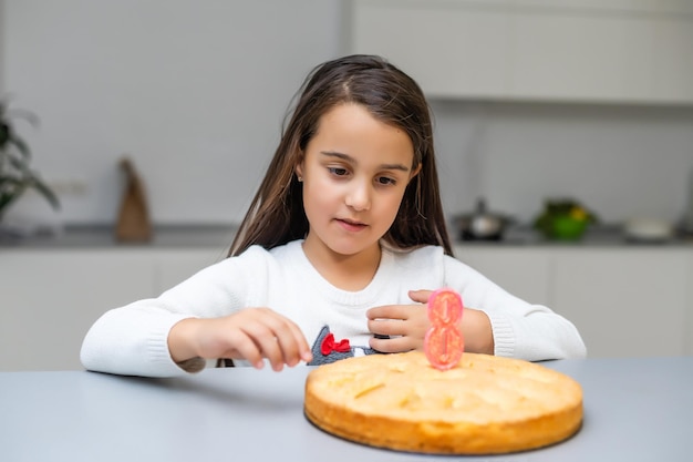 Girl in the birthday with a cake with candle