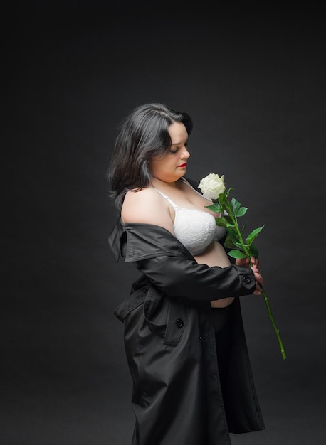 A girl in a black cloak and with a white rose