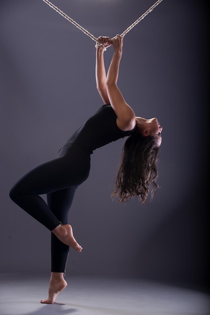 Girl in black clothes with a rope at the top