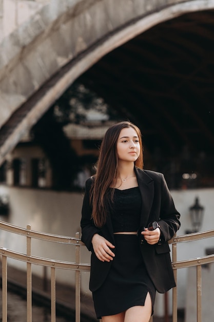 Girl in black dress walking in old city