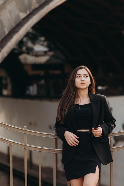 Girl in black dress walking in old city