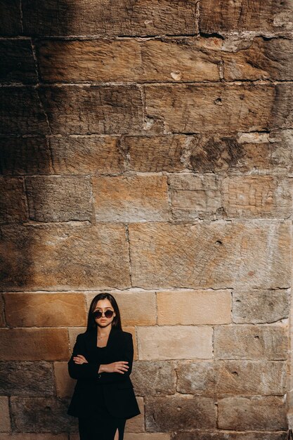 Girl in black dress walking in old city