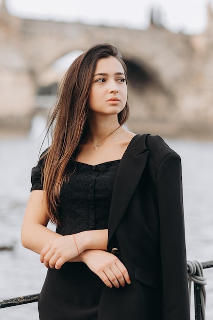 Girl in black dress walking in old city