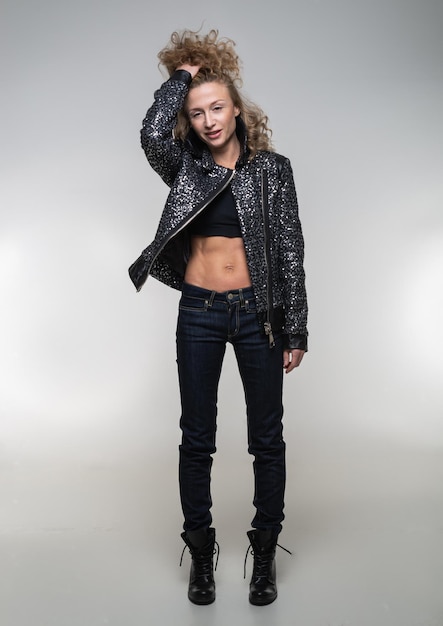 Photo girl in a black jacket with sequins and jeans, casual wear on a white background