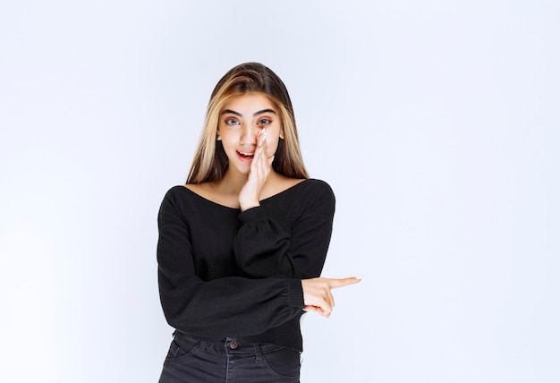 Ragazza in camicia nera che fa pettegolezzi.