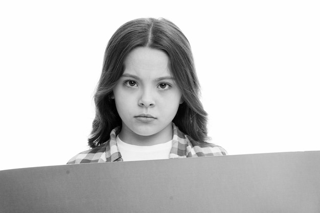 Girl blank surface copy space Advertisement concept Child cute girl looking sad while hold paper Regret to inform you Sad kid with blank paper advertisement Bad news Serious baby hold poster