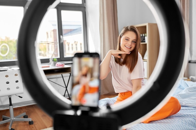 girl blogger with ring light streaming at home