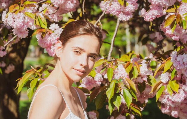 Girl in in blossoms cherry sakura outdoor portrait of beautiful sensual fashion girls posing near bl