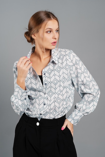 Girl in a blouse and trousers Studio portrait