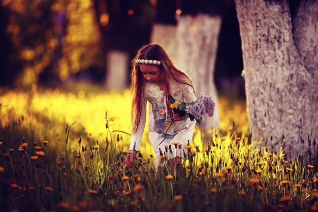 girl blowing a dandelion seeds flying