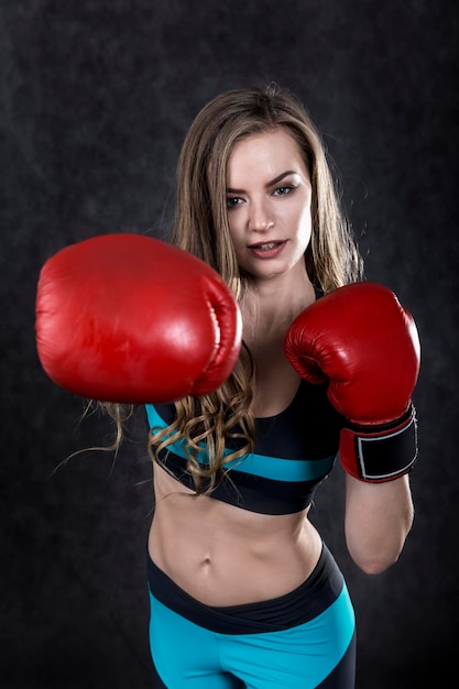 Girl in blue and black making a punch