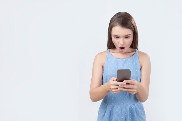 Girl in blue dress is surprised