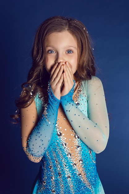 Girl in blue lycra dress with rhinestones for figure skating